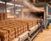Clay brick production process: green bricks stacked in an industrial drying chamber for moisture removal