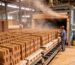 Clay brick production process: green bricks stacked in an industrial drying chamber for moisture removal